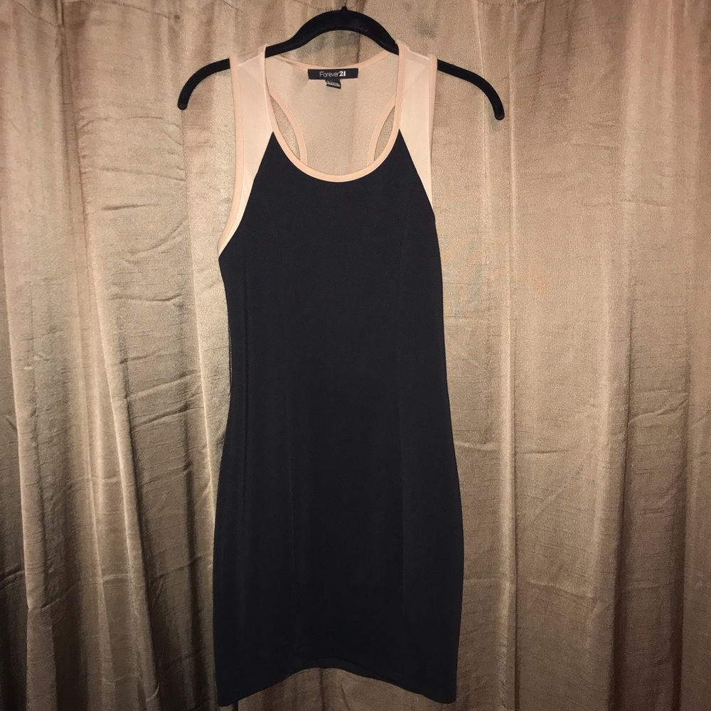 Black bodycon dress with tan mesh accents on straps and back
